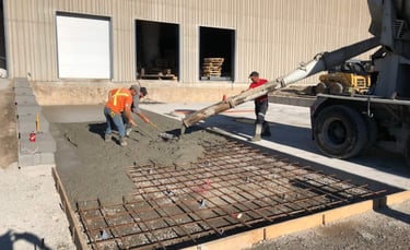 a man is pouring concrete into a concrete slab