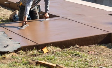 a man is using a knife to cut a concrete slab