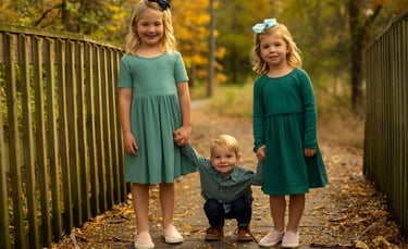 three young children holding hands