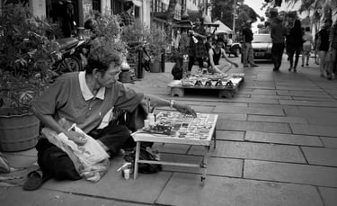 Peter Pickering photographs a street trader setting out his goods in Kota Tua, Jakarta