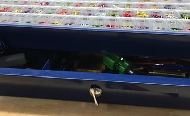 Close-up of lock rekeying pins and tools on a workbench