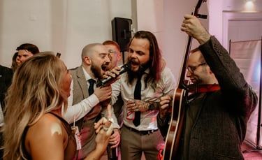 groom and groomsmen singing with wedding band