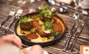 Arancini on a plate with sauce