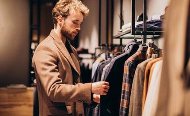 a man in a suit jacket is looking at a suit
