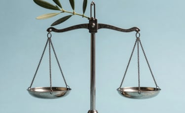 Symbolic photograph of an olive branch resting on a silver scale of justice. Clean, minimalist composition against a light blue background. Soft, professional lighting. Global / Spanish-speaking.
