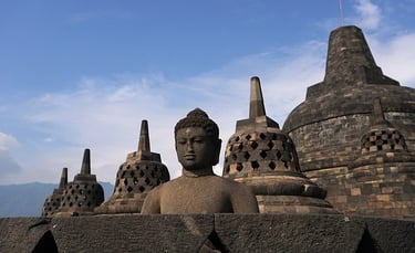 a buddha statue in front of a large buddha statue