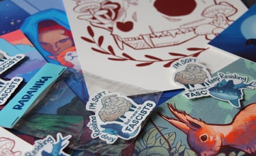 Prints and sticker scattered. Illustrations featuring animal, nature and social justice themes.