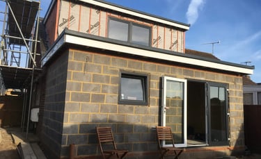 House extension under construction with blockwork and sliding doors in Brighton.