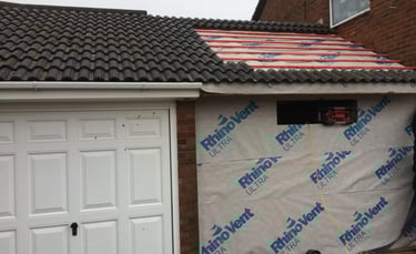Garage conversion in progress with roof work and structural preparation in Brighton.