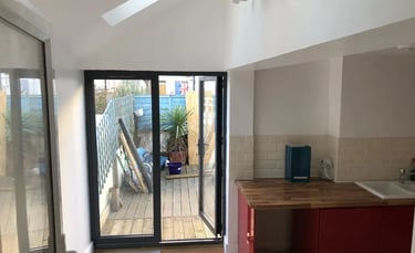 Modern rear house extension with bifold doors opening to garden in Brighton by T.L.E Constructing.