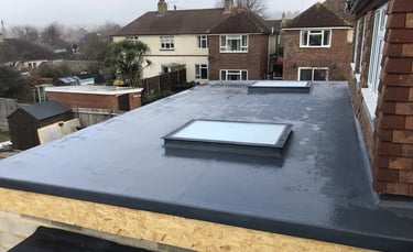 Rear loft dormer extension with rooflight on Sussex residential property.