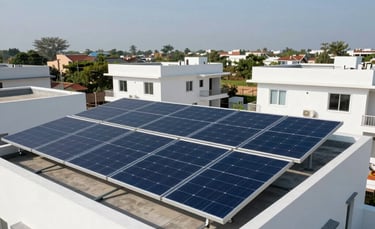 A high-angle photography shot of sleek navy blue solar panels installed on a modern residential rooftop in a sunny South Asian / Indian neighborhood in Lucknow. The composition is clean and focused, with bright white architecture and a clear blue sky, emphasizing reliable energy.