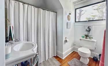 full bathroom with tub shower and large window 2123 rivermont carriage house