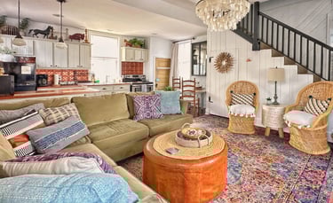 living room with green sectional and galley kitchen of 2123 rivermont's carriage house