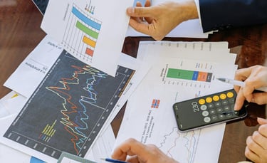 a few paper sheets with financial graphs on them