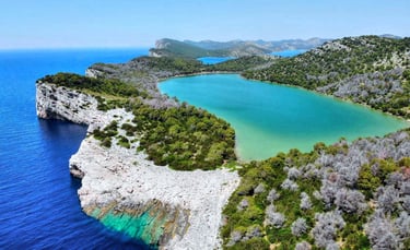 Cliffs of Telašćica Bay plunging into turquoise waters of Adriatic Sea.
