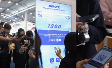 isitors interacting with large touchscreen games at INPEX exhibition booth