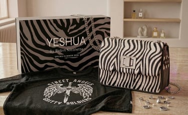 YESHUA by Robin Nicolette zebra print handbag with matching gift box and black mesh graphic t-shirt.