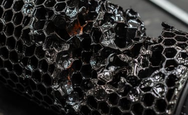 Close-up of a melted DPF ceramic core showing irreversible structural damage and fused honeycomb channels.