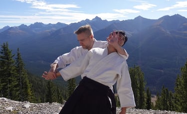 Aikidō students practicing ushiro kubi control technique during class at Calgary Rakushinkan dojo.