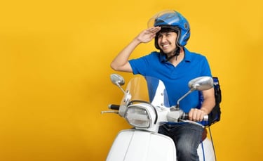 a man in a helmet and helmet on a scooter