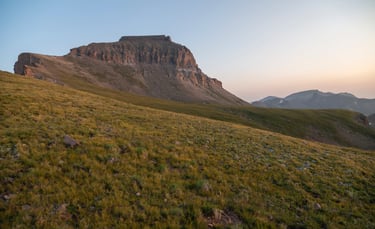  Uncompahgre Peak, the alpine tundra, and distant surrounding peaks aglow during summer sunrise