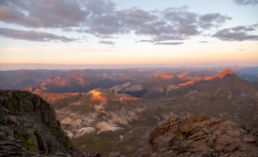 Uncompahgre summit sunrise: alpen glow shines on Wetterhorn Peak and the San Juan Mountains