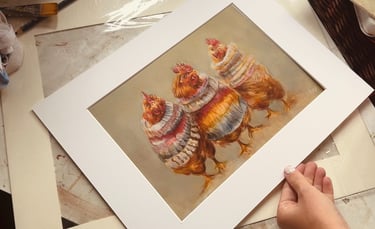 An art print by Alex Goddard showing a trio of chickens wearing colourful sweaters.