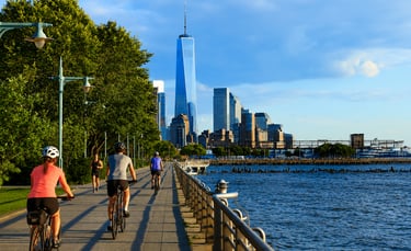 Cyclists riding beside the river on the Hudson River Greenway in New York