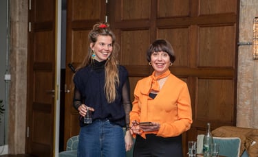 Two confident women, public speaking coaches, at workshop