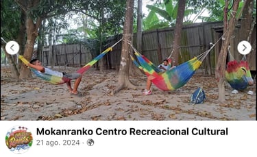 Guests relaxing in colorful woven hammocks tied to trees at Mokanranko Centro Recreacional Cultural.
