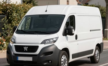 A clean, white Peugeot Boxer van without a license plate, parked professionally on a street in Île-de-France. Bright daylight, crisp commercial photography style, focus on the vehicle's reliable and well-maintained appearance against a French suburban backdrop.