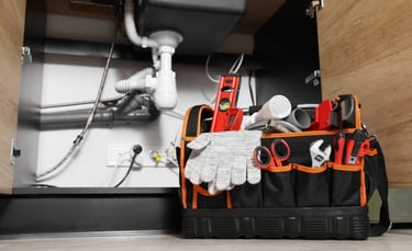 plumber's toolbox next to sink