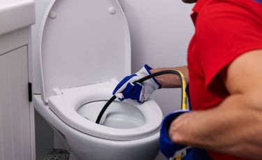 plumber fixing toilet clog