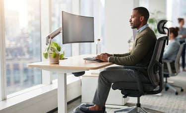 Modern ergonomic desk setup showing correct monitor, chair, and workstation positioning.