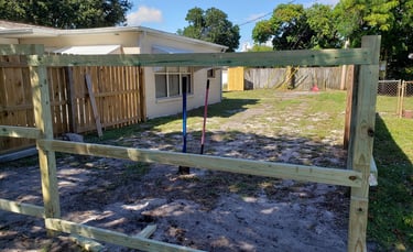 Handyman installing wood picket fence