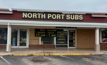 Storefront of North Port Subs restaurant offering Philly cheesesteak and sub sandwiches.