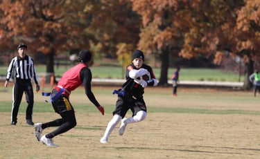 2 people playing flag football.