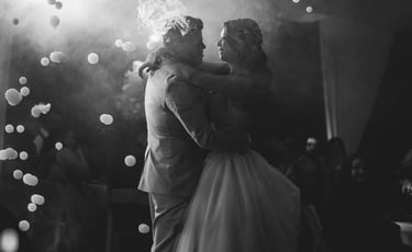 a bride and groom share a kiss at their wedding reception