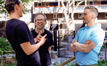 A personal trainer and his clients discussing exercise