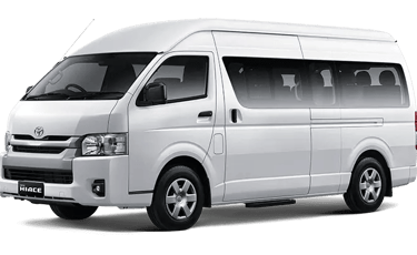 Toyota Hiace warna putih dengan pintu geser pandangan dari kiri depan.