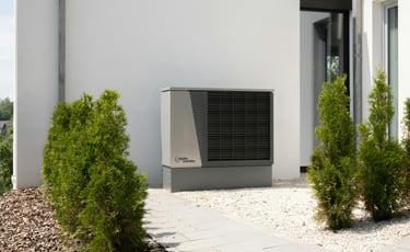a small air conditioner sitting in front of a house