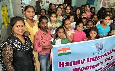 Group of twenty girls at Shahbad Dairy Slum, some holding up an International Women's Day banner.