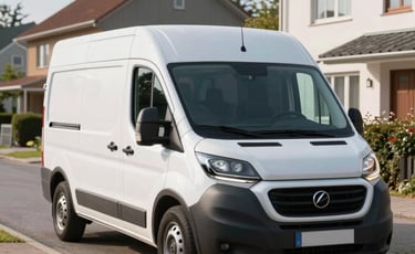 A clean white moving van parked on a tidy residential street in a Northern European neighborhood. Bright morning light, sharp focus, professional photography style.