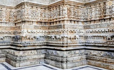 Intricate stone carvings at Jagdish Temple in Udaipur, showing detailed figures and mythological motifs.