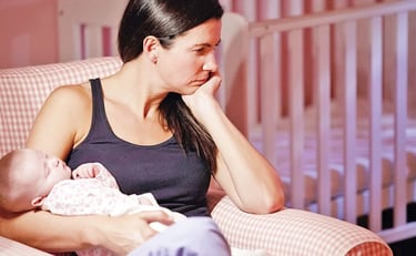 a woman sitting in a chair with a baby