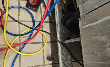 Appliance repair technician is replacing fridge compressor