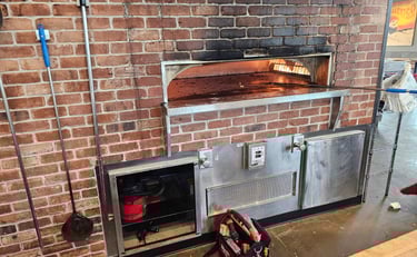 appliance repair technician is replacing control board in commercial oven