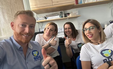a group of people sitting at a table with thumbs up