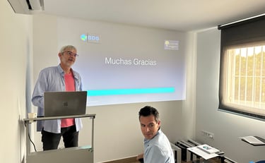 a man standing in front of a presentation screen